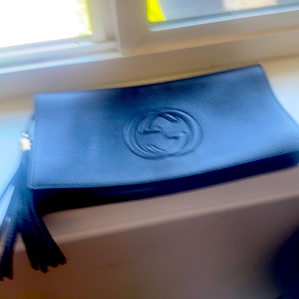 Black leather Gucci clutch. Comes with dust bag and authenticity card